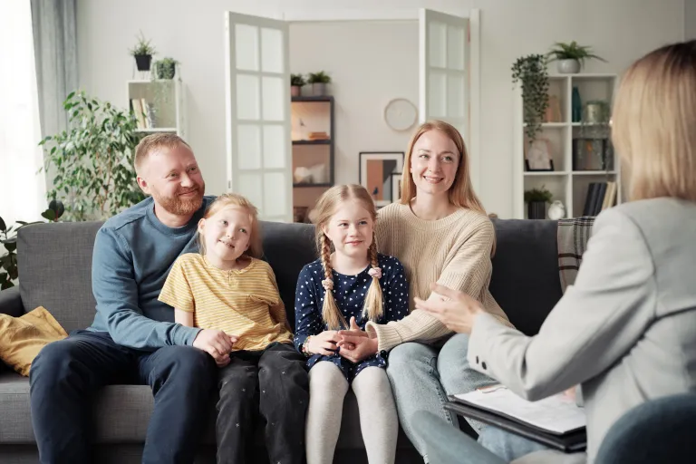 Family with children meeting a counselor during family therapy