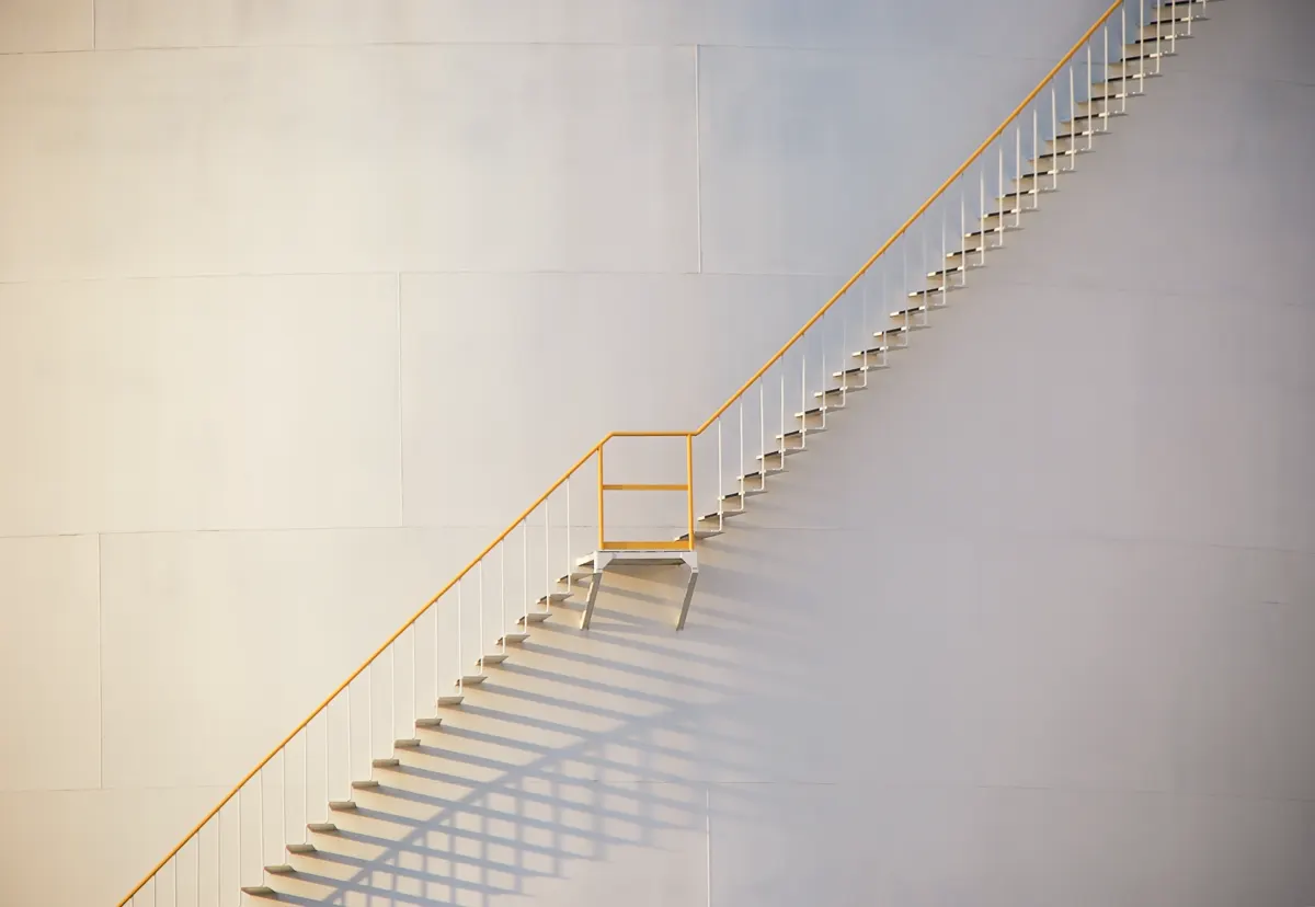Minimal ascending staircase with brass rail — deliberate career progression
