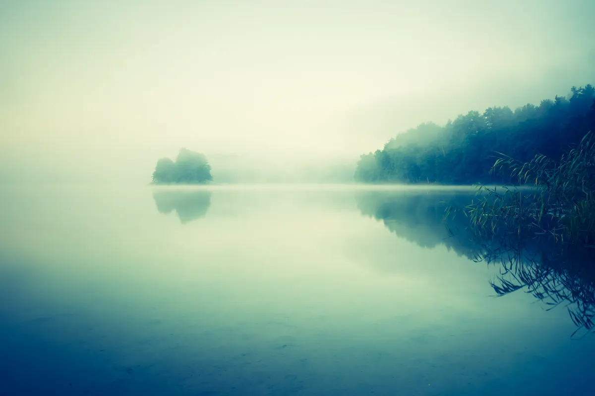 Still lake at dawn with morning mist — recovery as a discipline