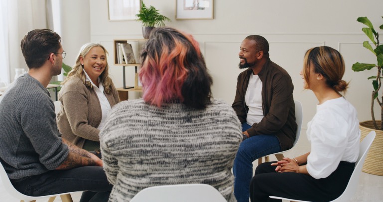 Group members showing support and unity during therapy at ZipHealthy